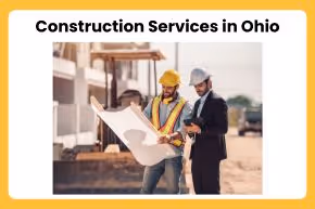 Two construction professionals reviewing blueprints at a construction site.